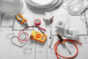 Different electrician's supplies on electrical scheme